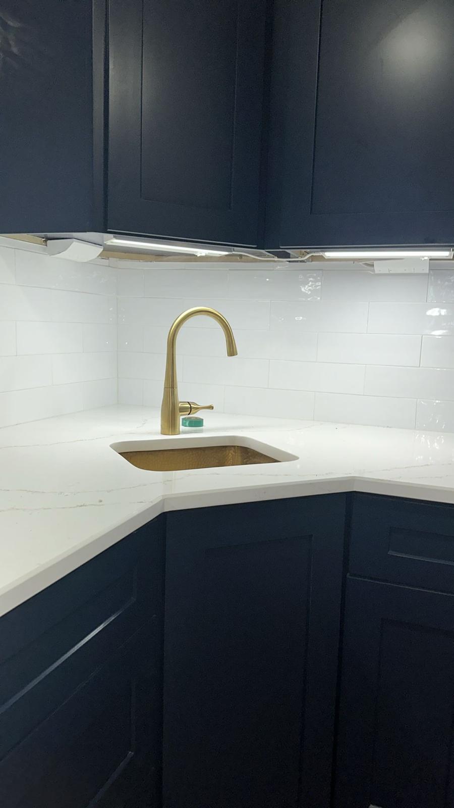 Navy kitchen cabinets with gold fixtures